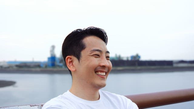 Man smiling by the riverside