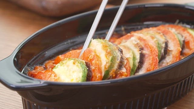 Chopstickful of deliciously cooked zucchini tomato ratatouille