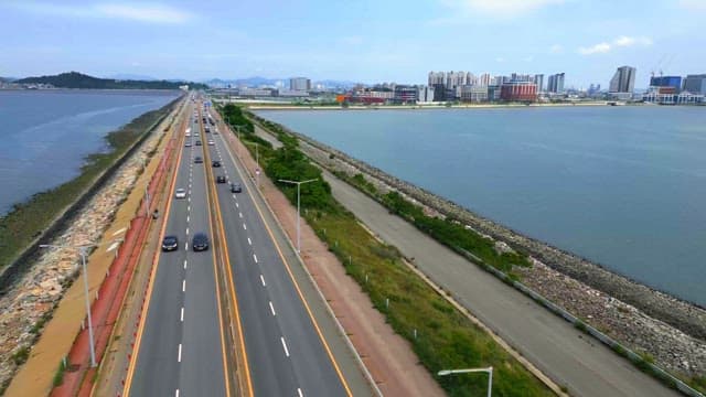 Coastal highway with city skyline
