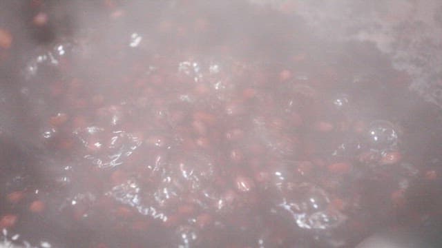Red beans boiling in a pot of water
