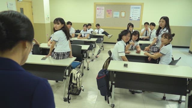 Students concentrating on teacher in classroom