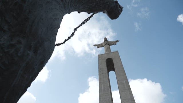 Towering Statue of Christ the Redeemer Under a Clear Sky