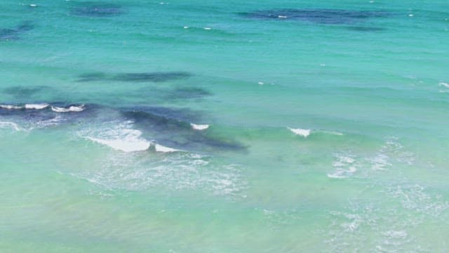 Waves gently rolling on a turquoise sea