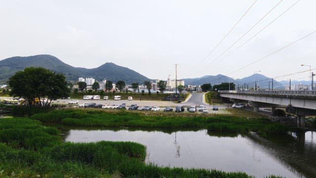 Riverside with mountains and city in the background