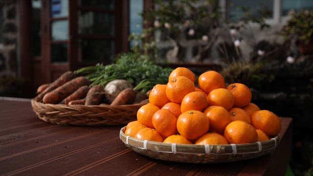 Fresh tangerines and carrots on a table