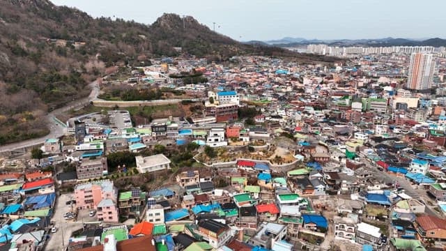 Colorful hillside village with mountains