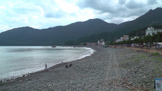 Rocky beach with mountains in the background