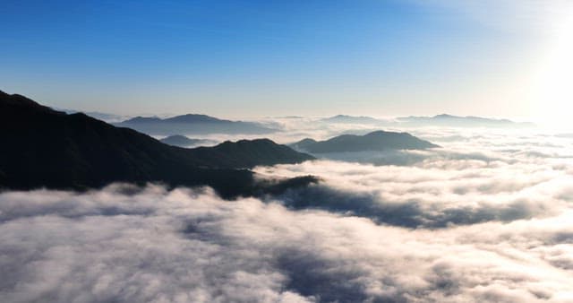 Mountains and clouds under a clear sky