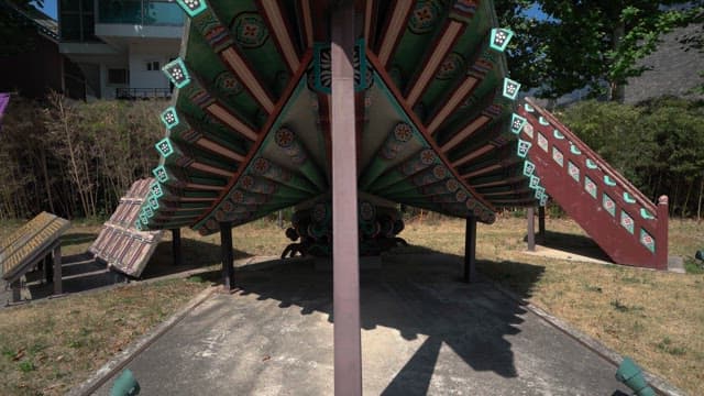 Traditional Korean roof structure displayed in an urban park