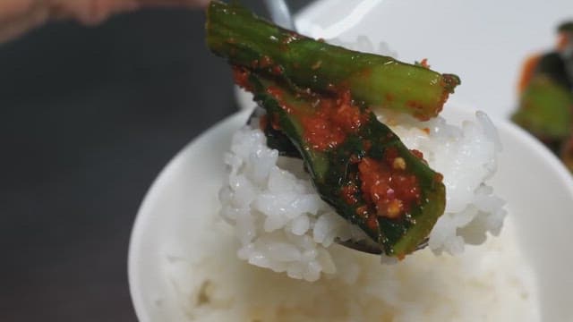 Rice in a white bowl served with kimchi
