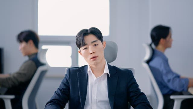 Man sitting in the office with a tired face