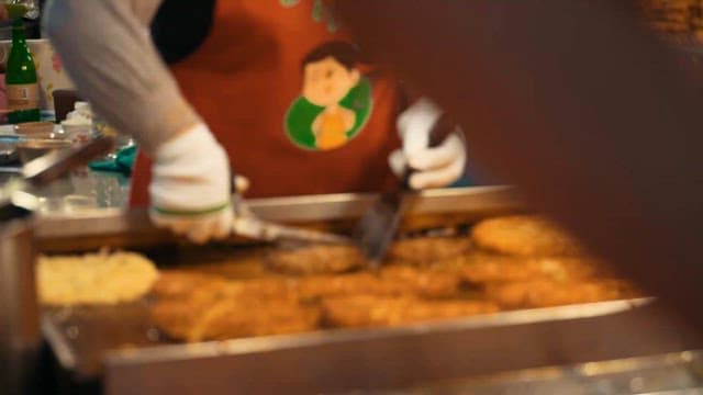 Preparing traditional street food at a market