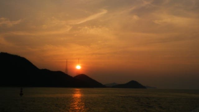 Sunset Behind the Mountain Over Sea