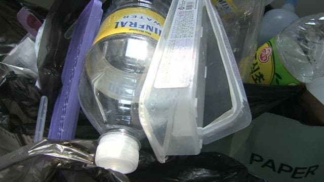Assorted plastic bottles inside a trash can