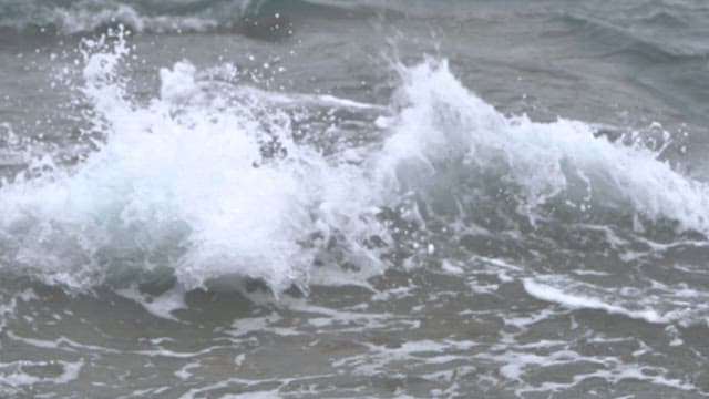 Waves crashing violently, creating white foam