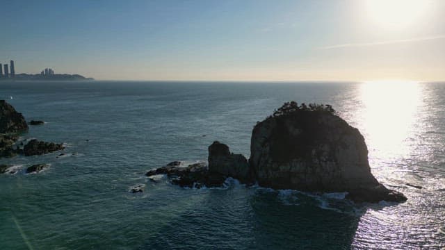Rocky island in the ocean with sunlight
