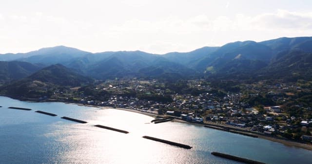 Coastal village with mountains in the background