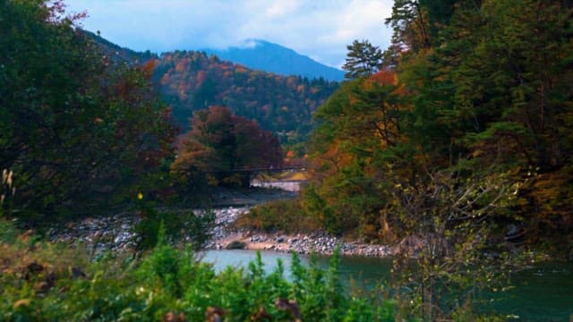 Autumn colors along a serene mountain river