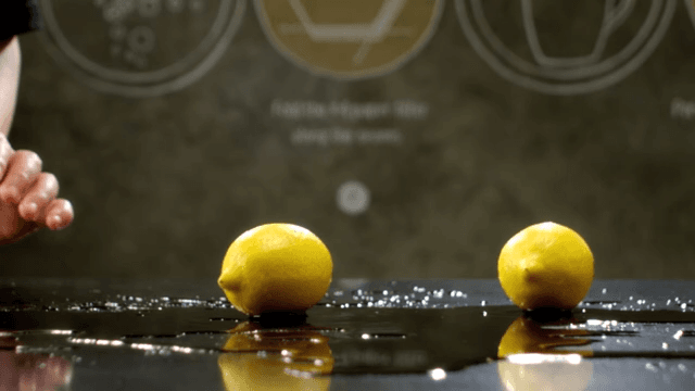 Lemons rolling over a shiny surface