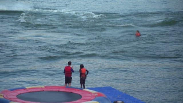 People Jet Skiing on the River on a Summer Day