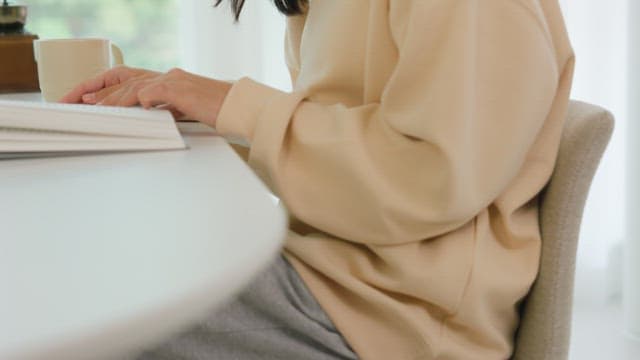 Woman Reading a Book While Drinking Coffee