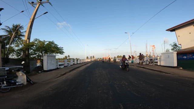 Morning driving on a bridge with few cyclists