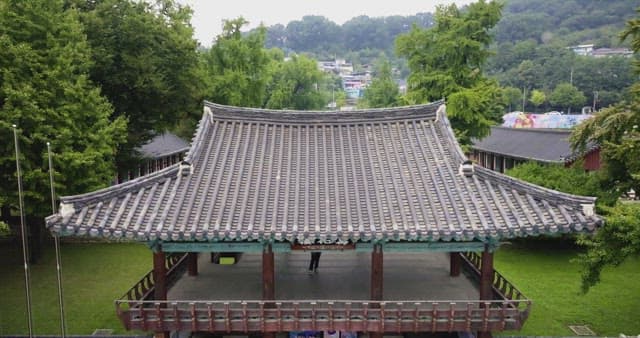 Traditional Korean architecture surrounded by lush greenery