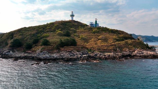 Lighthouse on a scenic coastal hill