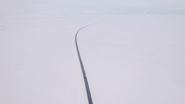 Long road stretching through snowy plains