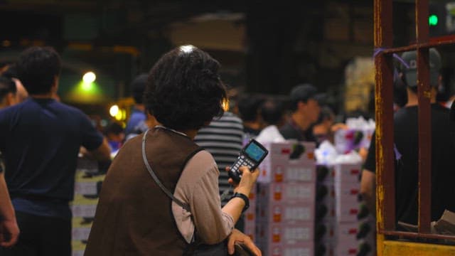 A woman working in a busy indoor market