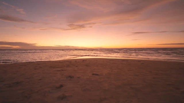 Sunset on a Tranquil Beach with Gentle Waves