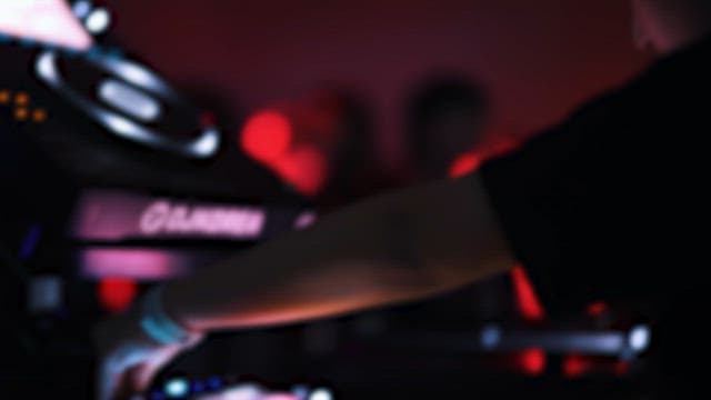 DJ Mixing Music with Electronic Musical Equipment