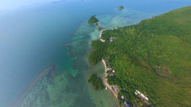 Peaceful island covered in lush green tropical forests