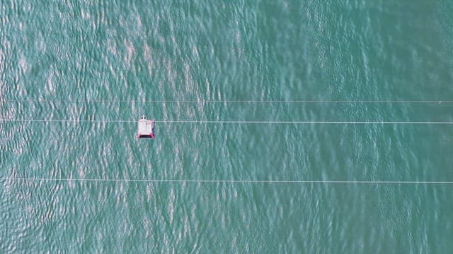 Cable car moving over a vast sea