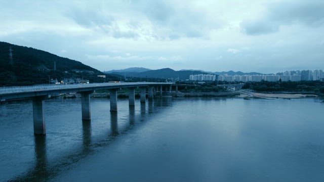 Bridge over a river with city skyline