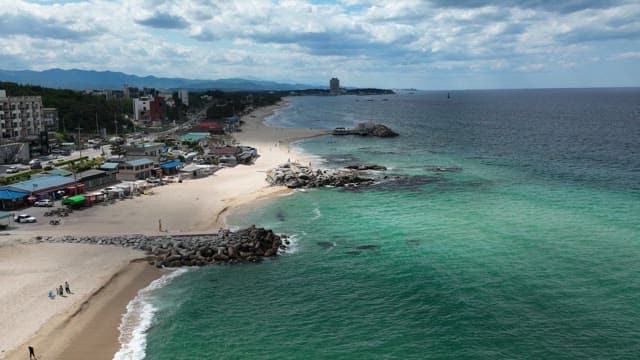 Beachfront view with coastal town and turquoise water