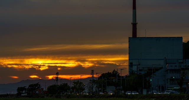 Vibrant sunset scenery beyond the city's industrial complex