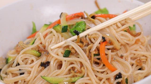 Chopstickful of anchovy bibim noodle with vegetables and soy sauce
