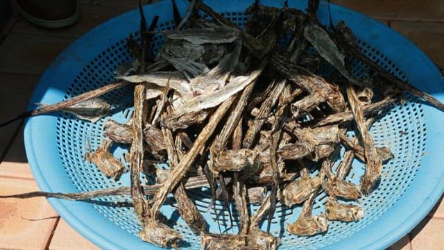 Dried green eel goby in a blue basket