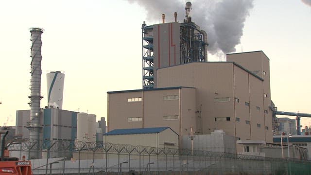 Industrial Plant Emitting Smoke at Dusk