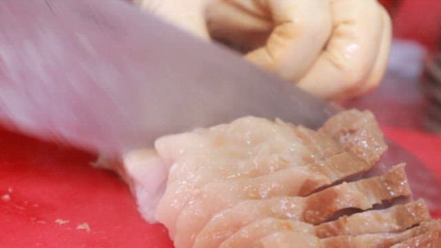 Preparing Food by Cutting Boiled Pork and Skate on a Cutting Board