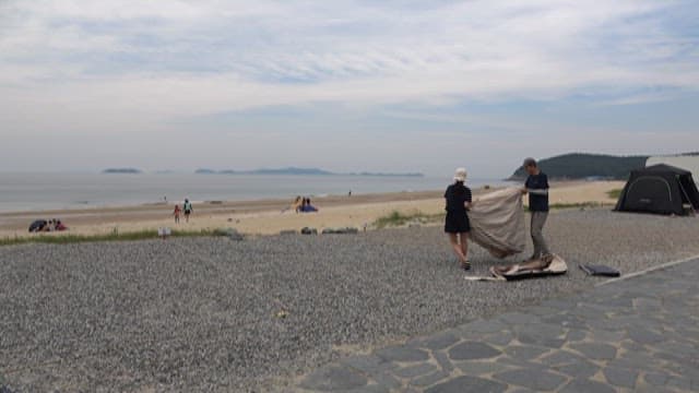 Setting up a Tent on a Gravel Beach