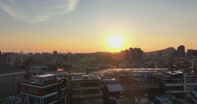 Sunset over a bustling city skyline